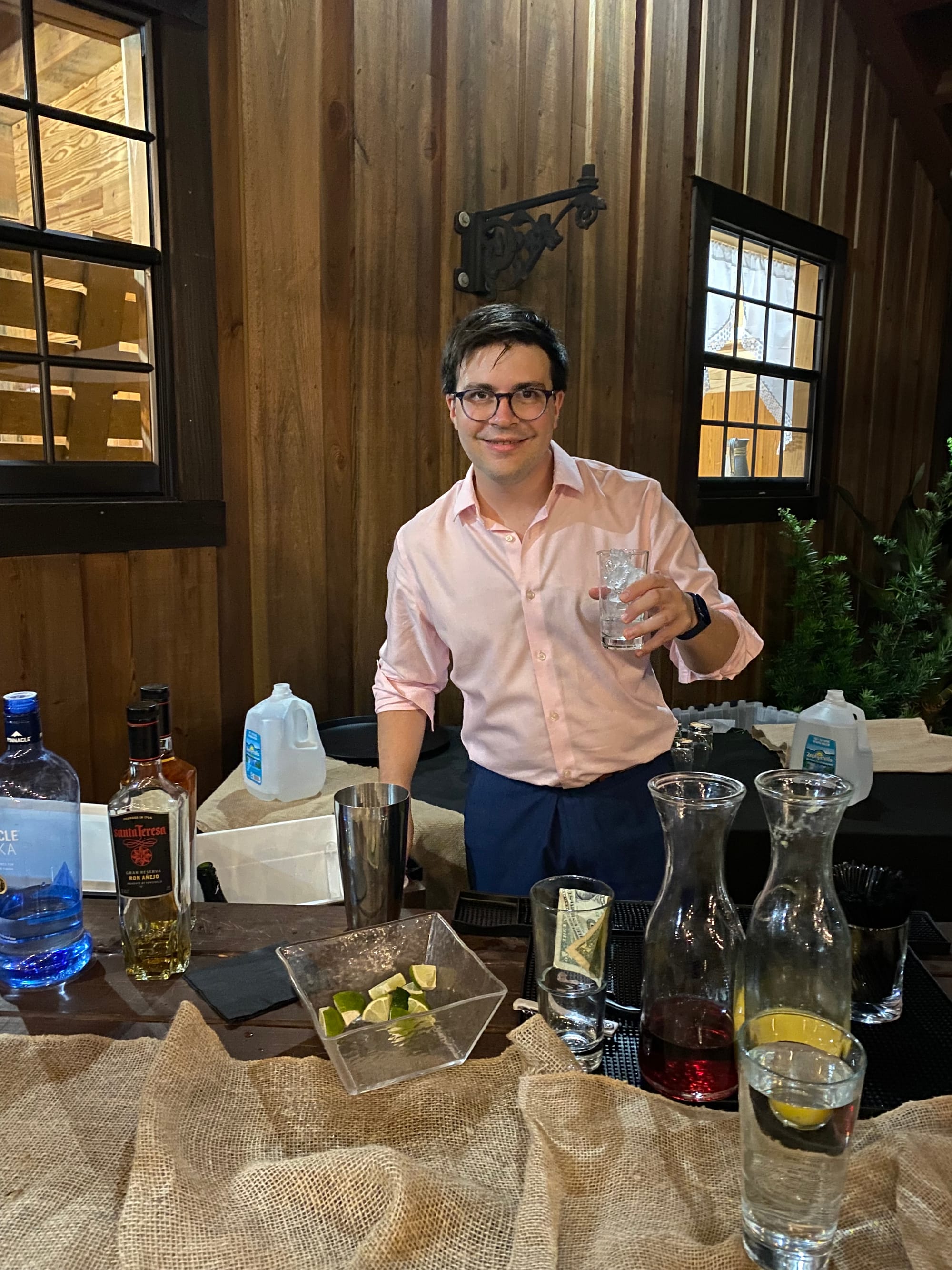 The author serves up an iced drink from behind an outdoor bar.