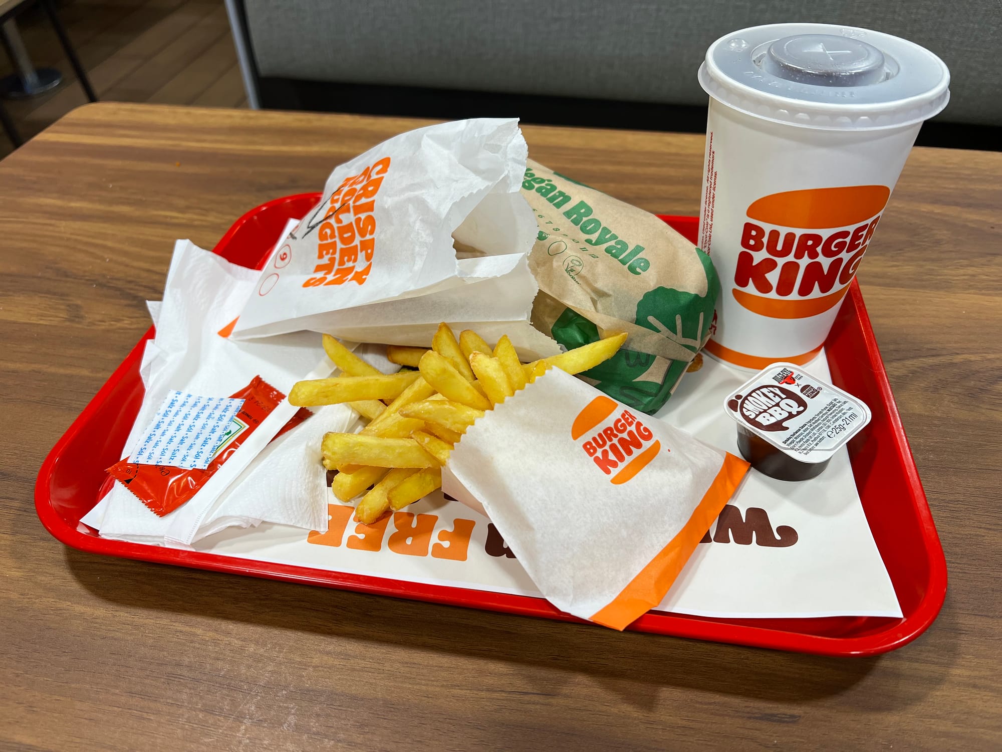 A tray of Burger King food: the Vegan Royale, faux nuggets, fries, and a tall drink of Day Soda.