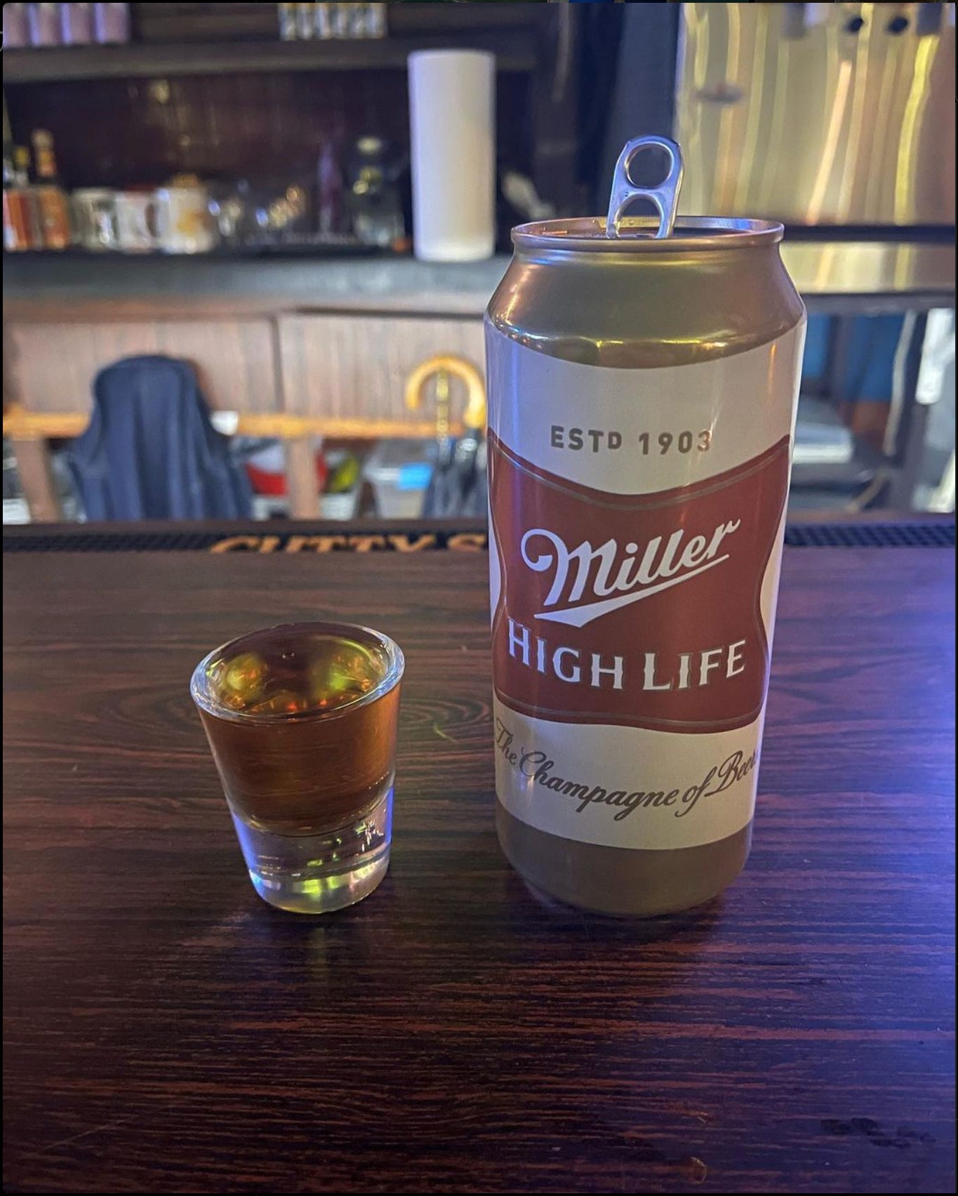 A shot of whisky and a Miller High Life tall boy.