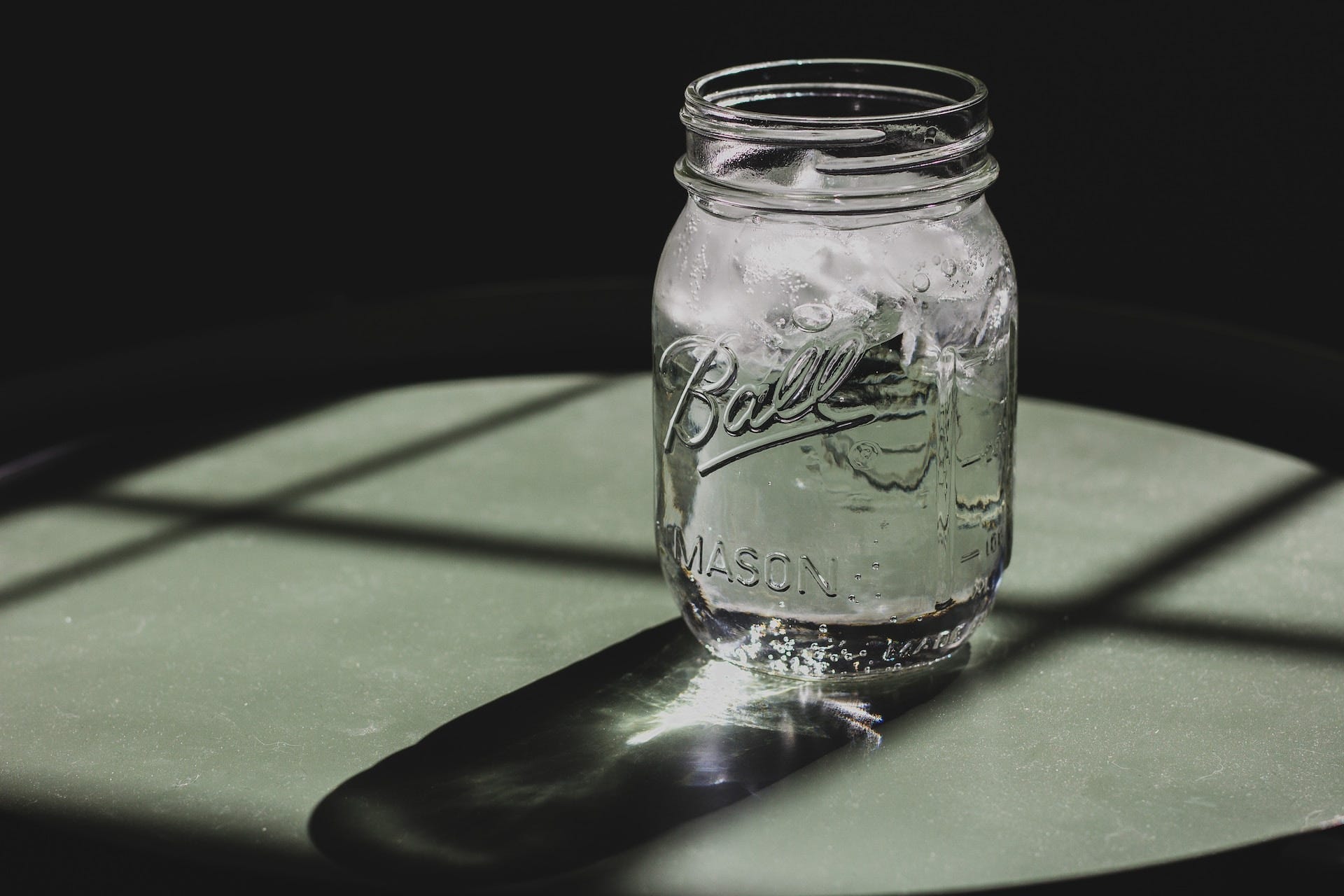 A mason jar full of ice water.