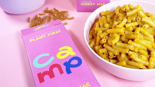 A box of Camp vegan mac and cheese alongside a bowl of the cooked item.